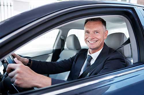 Business man driving a nice car.