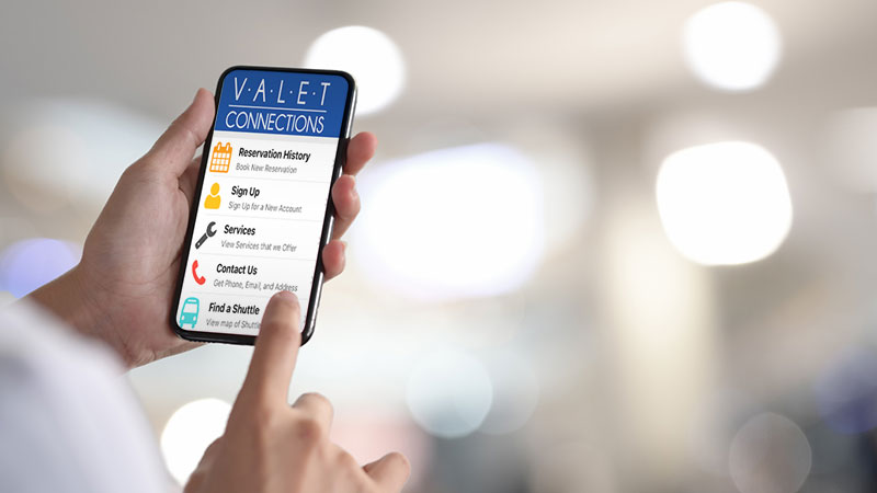 Hand holding phone with Valet Connections App on screen.
